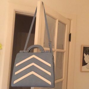 Big blue bag with white chevron stripes on front